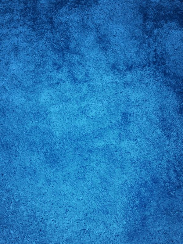 Abstract Grunge Decorative Relief Navy Blue Stucco Wall Texture. Wide Angle Rough Colored Background With spot light